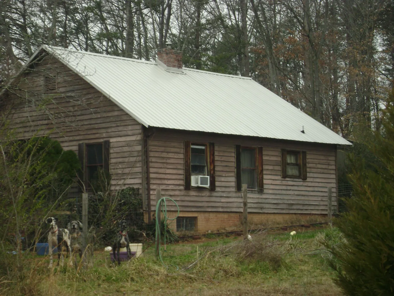 White metal roof on an old wood sided farmhouse, from a Metal Roof Installation job in Malvern